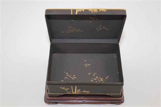 A Japanese gold and silver inlaid iron box and cover, signed Komai, Meiji period, 11cm, rosewood stand